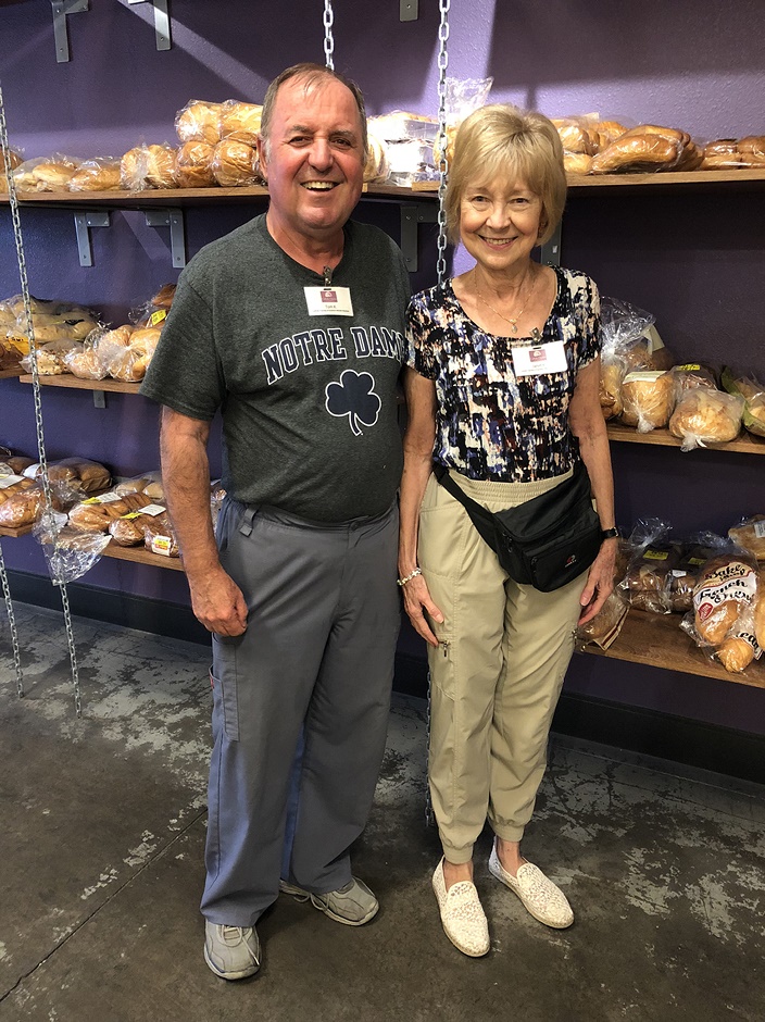 Thomas and Janet take a break from stocking shelves in the Hands of Hope Food Pantry