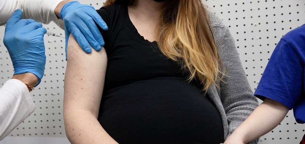 A pregnant woman in Schwenksville, Pa., receives a vaccine for the coronavirus Feb. 11, 2021. (CNS photo/Hannah Beier, Reuters)