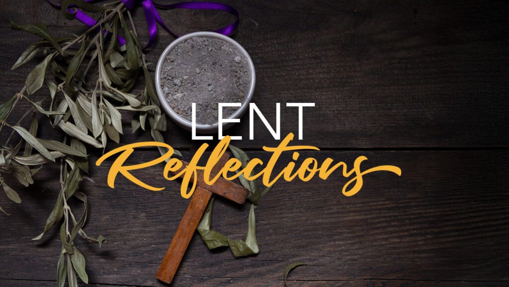 A bowl of ashes and a wooden cross