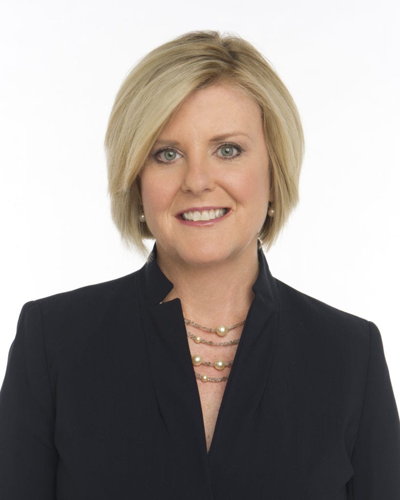 Anne Thompson, NBC News correspondent, smiles and is wearing a black blazer and a pearl necklace.